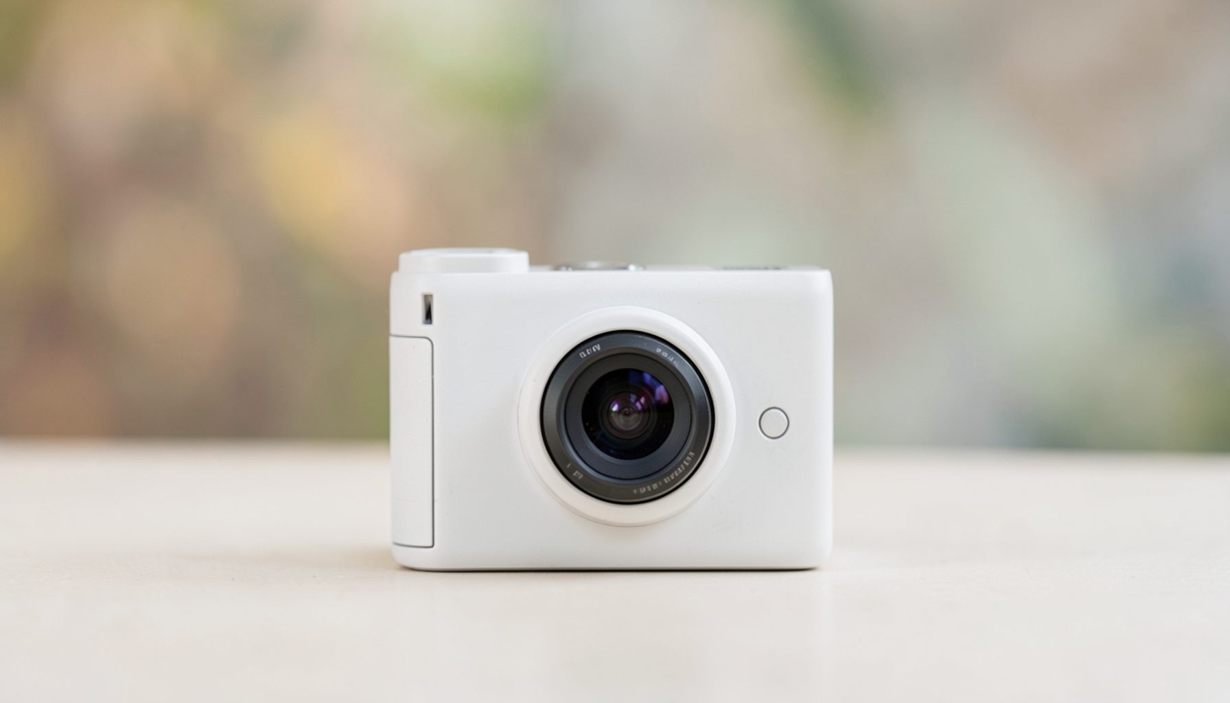 A lightweight camera unit with a minimalist design, shown against a soft-focus background